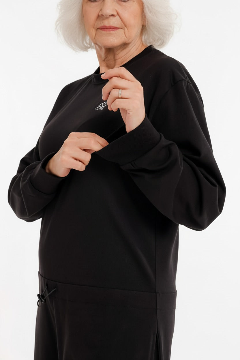 ComfortCure demans bakım tulumu siyah renk kadın model arka fermuar açık güvenli tasarım